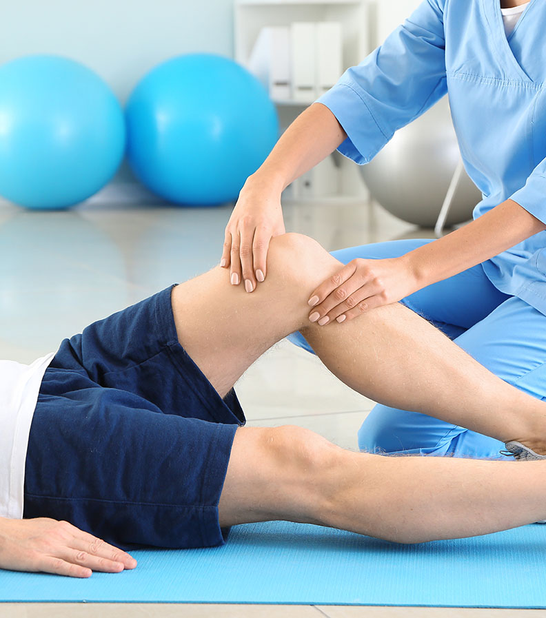 Physiotherapist working with male patient in rehabilitation cent