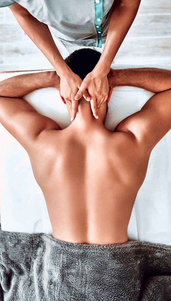 Male receiving neck massage in spa salon