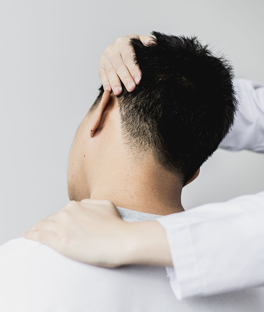 A professional physiotherapist is stretching the neck muscles of