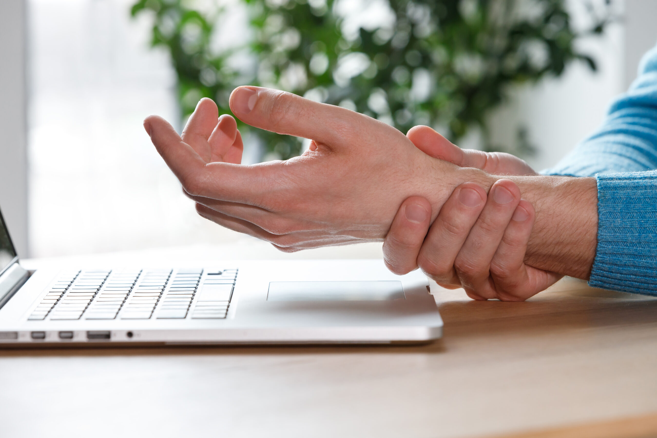 Carpal tunnel syndrome. man arms holding his painful wrist